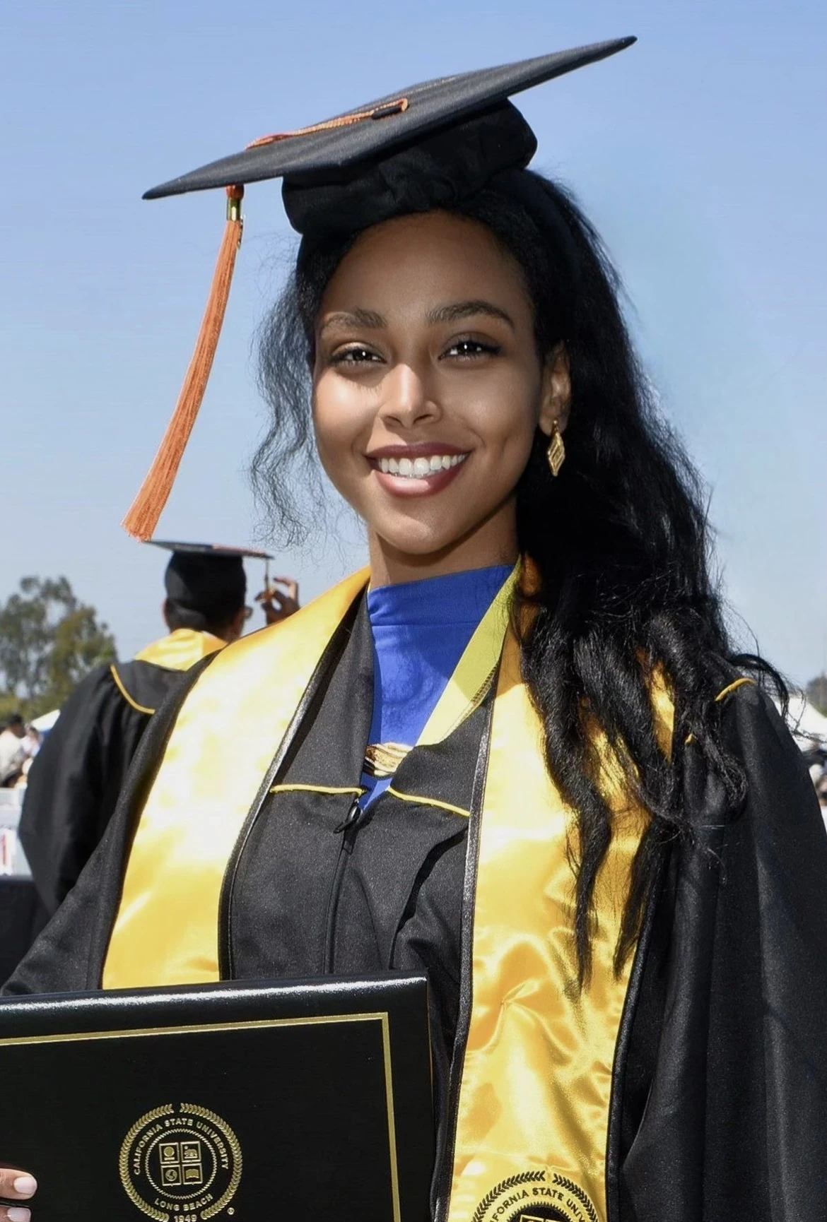 Zarya Amin wearing her graduation cap and gown at CSU Long Beach